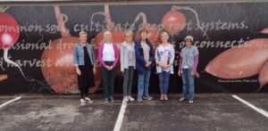 Board Members and Manager standing before new Mural